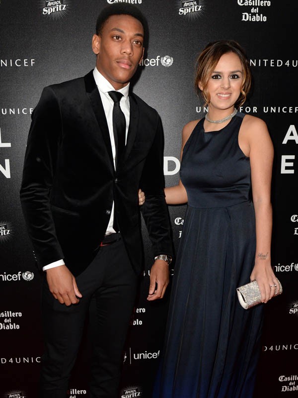 Manchester United's French striker Anthony Martial (L) and his and his wife Samantha pose for pictures on the red carpet as they arrive to attend the "United for UNICEF Gala Dinner" at Old Trafford in Manchester, north-west England, on November 29, 2015.   AFP PHOTO / OLI SCARFFOLI SCARFF/AFP/Getty Images